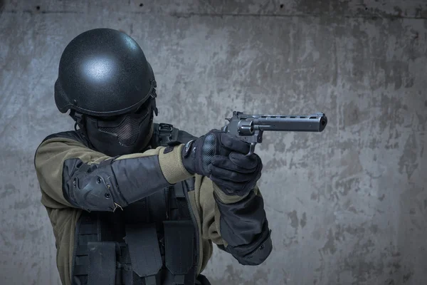 Terrorist in helmet with big gun in hands