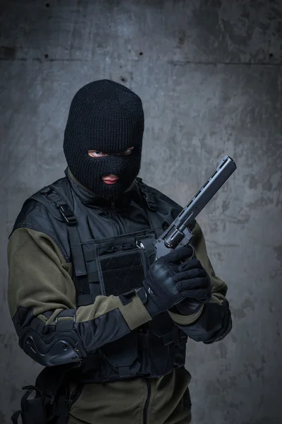 Terrorist in balaclava with big gun rifle in hands