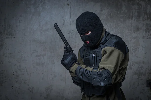 Terrorist in balaclava with big gun rifle in hands