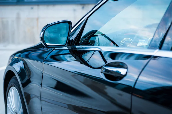Closeup shot of black modern car\'s side mirror