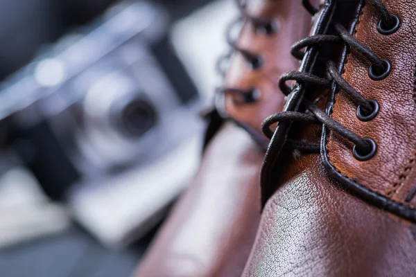 Brown leather shoes on black floor