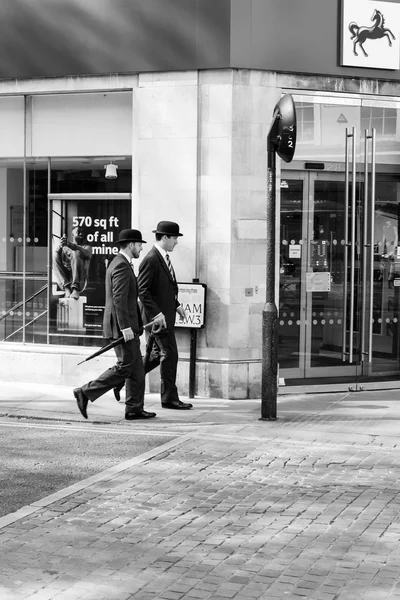 Two gentlemen dress walking on the street of London