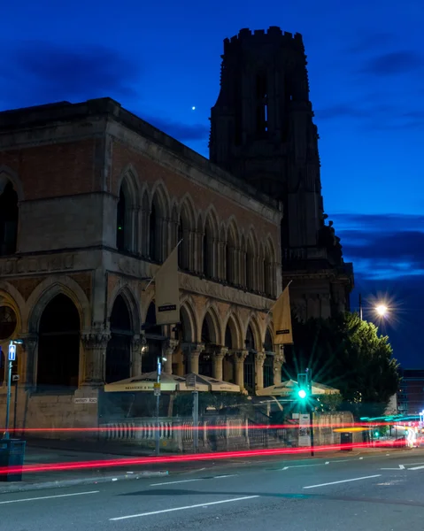 ENGLAND, BRISTOL - 13 SEP 2015: Clifton, Browns with WIlls Memorial Building by night, motion-blur car lights