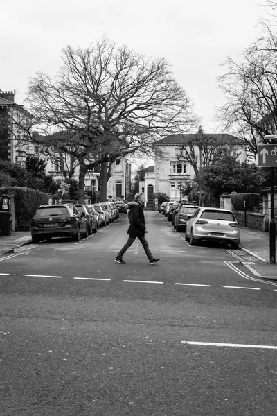 A pedestrian crosses the streets