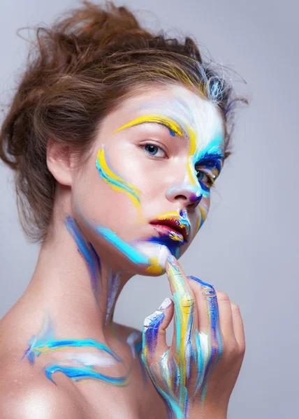 Painted beautiful woman face, artistic make up