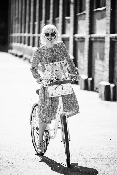 Hipster painter. Fashion blond woman with retro white bicycle street style outdoor portrait