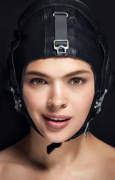 Woman in black helmet and professional makeup close up portrait