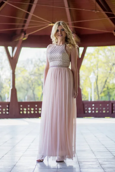 Blond woman in evening gown posing