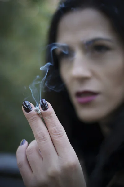 Woman smoking in park