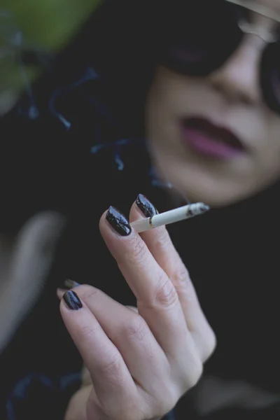 Woman smoking in park