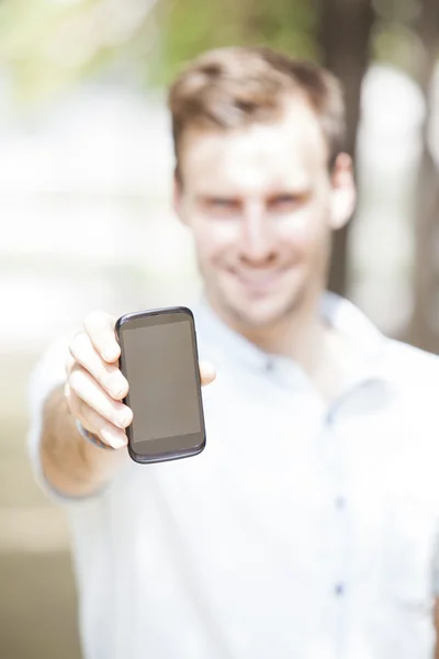Happy man showing a mobile phone screen