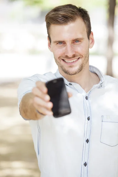 Happy man showing a mobile phone screen