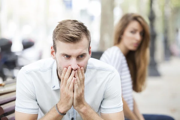 Portrait of young woman and man outdoor on street having relationship problems