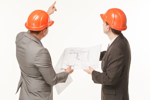 Builders discussing drawings building plan