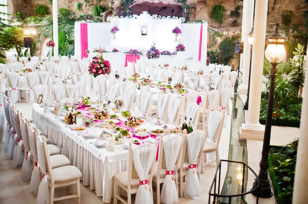 Amazing wedding table in pink style with flowers and foods