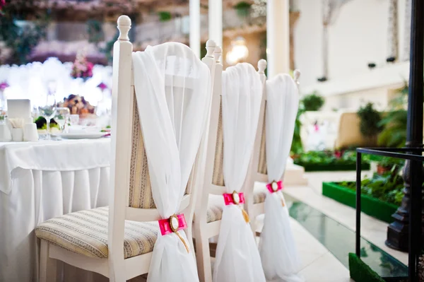 Wedding chairs with pink bow and brooch