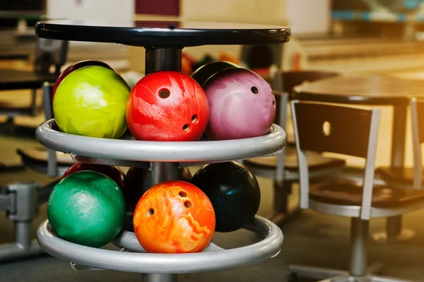 Many colored balls for bowling at table to store