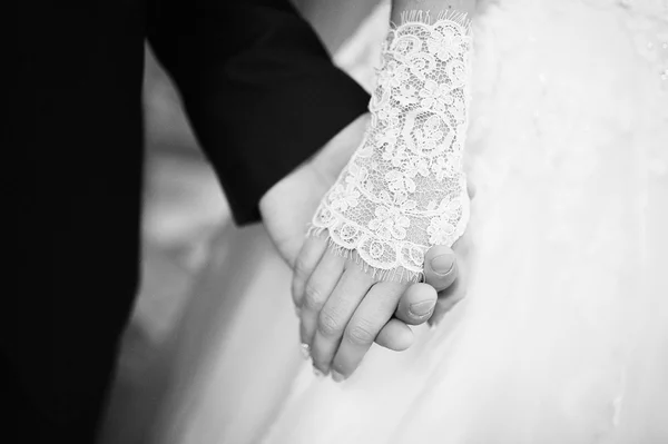 Black and white photo of close up hands of wedding couple