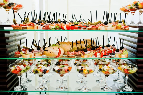 Buffet table of reception with burgers, cold snacks, meat and sa