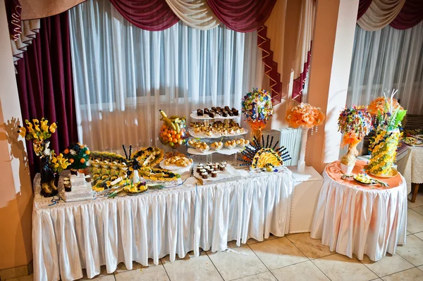 Wedding reception table of sweet candies and fruits