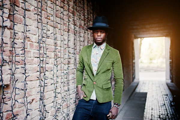 Fashion portrait of black african american man on green velvet j