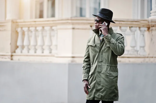 Fashion portrait of black african american man on green coat clo