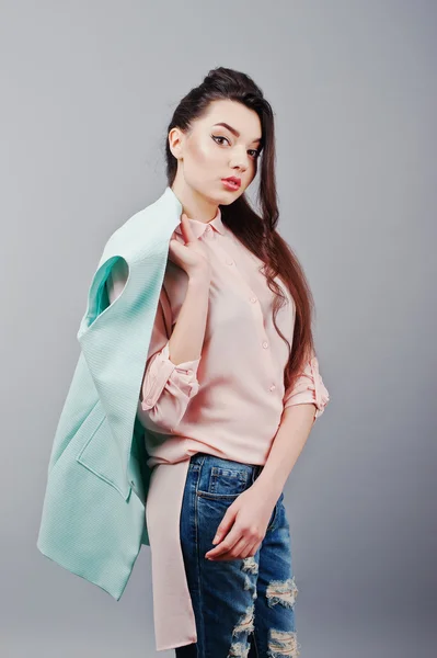 Portrait of young brunette girl wearing in pink blouse, turquois