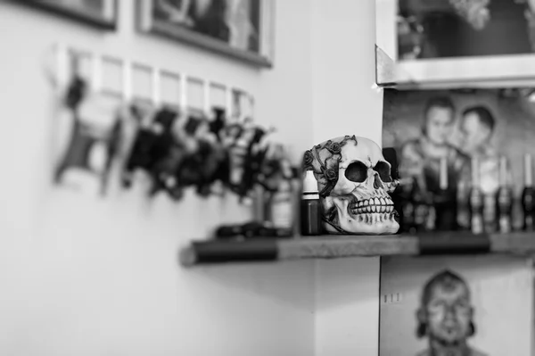 Skull at tattoo saloon. Black and white photo