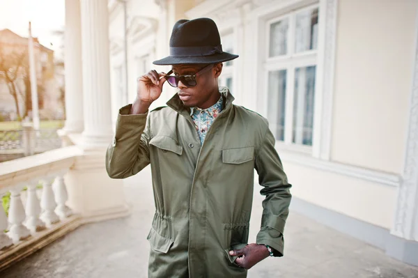 Fashion portrait of black african american man on green coat clo
