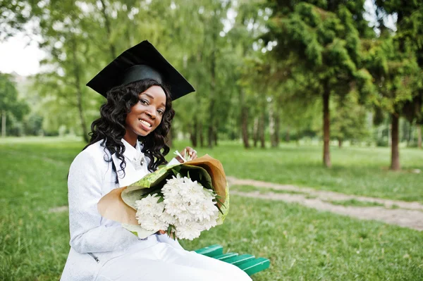 Happy beautiful black african american girl with hat graduates