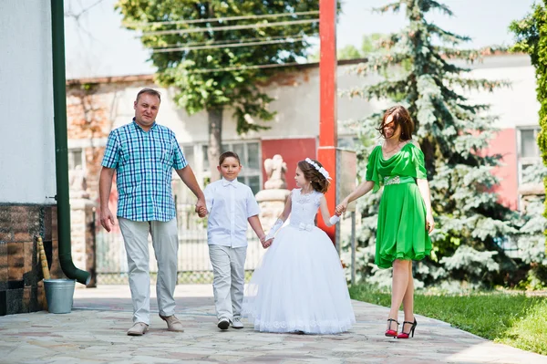 Happy family at first holy communion walking background church c