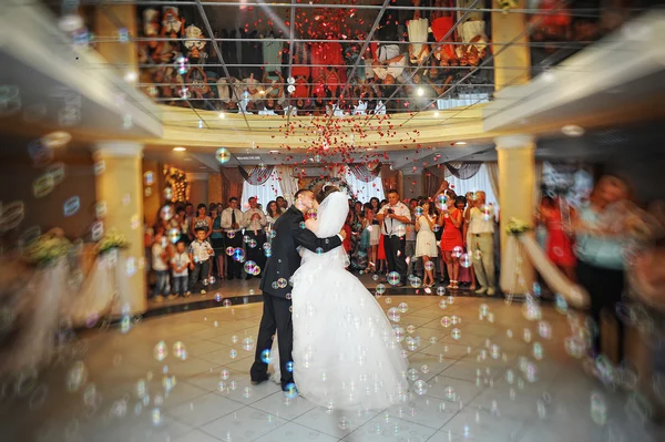 Bride and groom dancing in the restaurant on bubbles