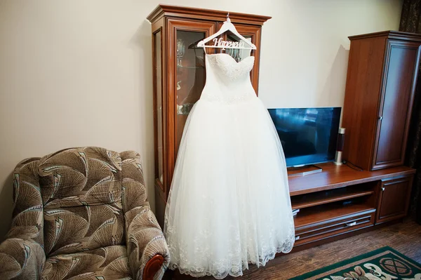 White wedding dress on decorated hangers