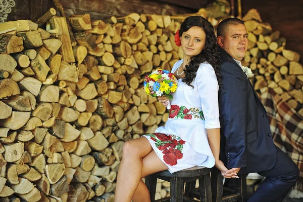 Couple on traditional dress bakcground wood sticks