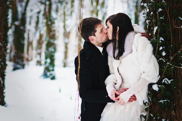 Wedding couple in winter snowly forest