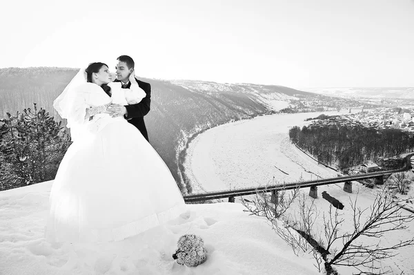 Young wedding couple at sunny winter day