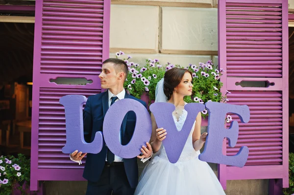 Newlywed with decor violet word love background purple wooden wi