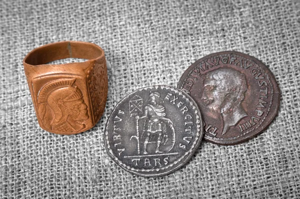 Signet ring and two coins of the ancient Roman Empire