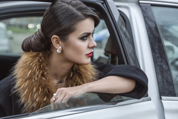 Brunette lady in the car.