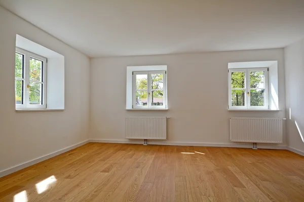 Living room in an old building - Apartment with wooden windows and parquet flooring after renovation