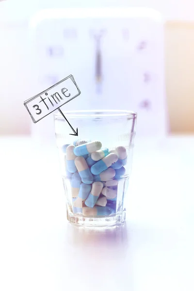 Medicine and clock background, time to take pills.