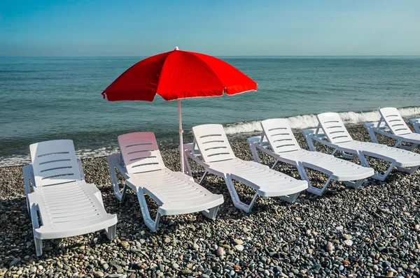 Sun umbrella and beach beds on the shingle beach