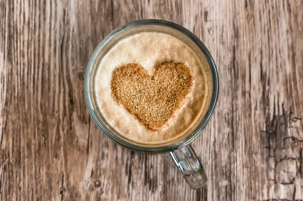 Cup of coffee with a heart shape symbol