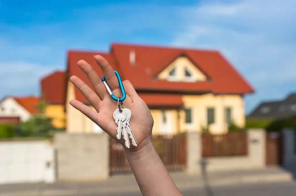 Real estate agent giving house keys to a new property owner