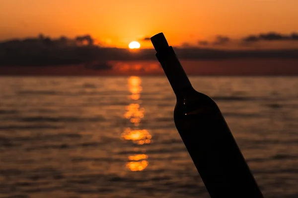 Beautiful sunset and silhouette of a bottle of wine