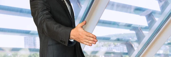 Businessman in suit giving hand for handshake