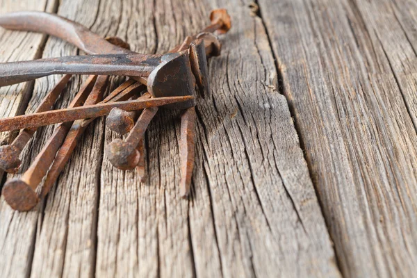 Old nails and clipper on rustic wooden table