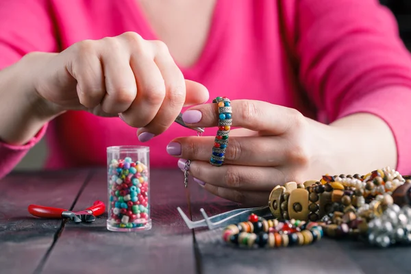 Relax hobby. Female make craft beads