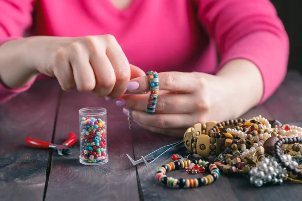 Relax hobby. Female make craft beads