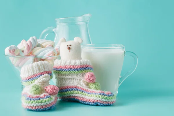 Glass of the milk on plain aquamarine background